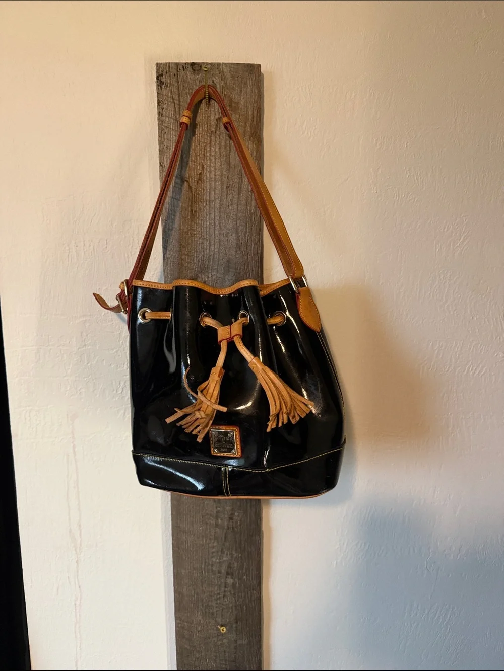 Dooney & Bourke Black Patent Leather Drawstring Shoulder Bag with Tan Trim